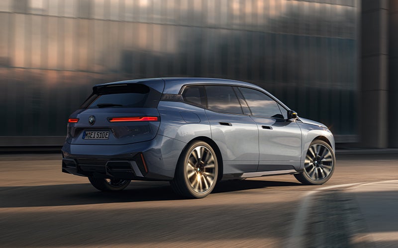 The BMW iX driving with the front wheel turned. | BMW of Tallahassee in Tallahassee FL